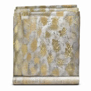 Table roll fabric folded on its bolt, abstract gold blotch pattern on a woven silver-grey ground