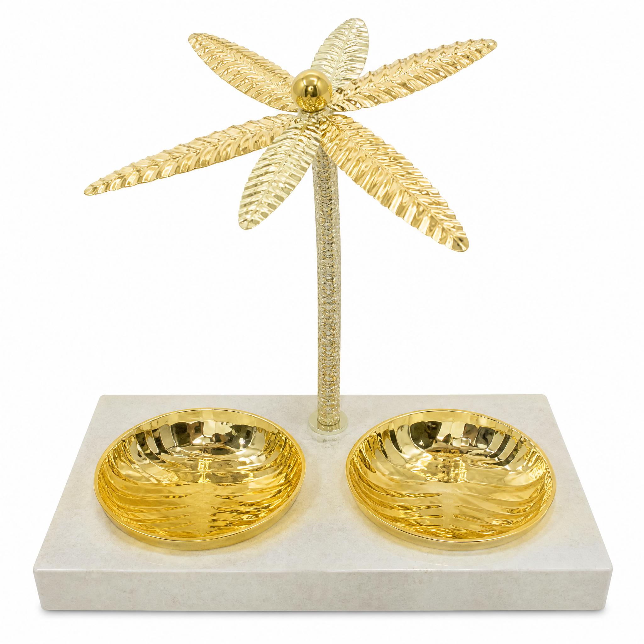 Two round gold dishes on a pale stone-look tray beneath a tall gold palm tree stand