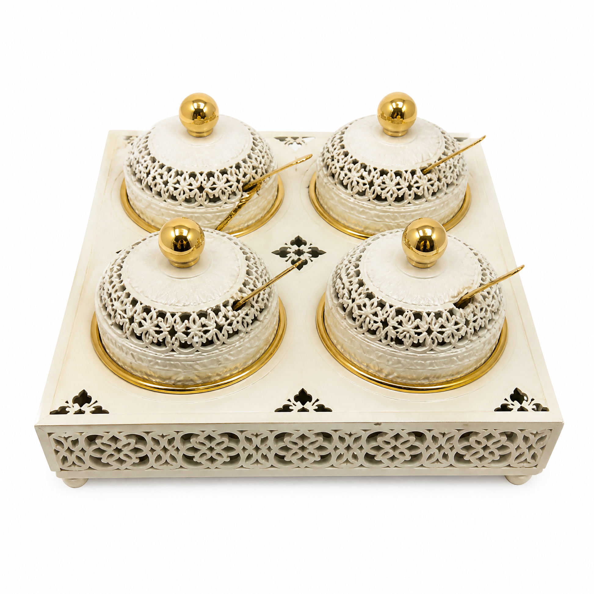 Four ivory and gold lidded jars with ball finials, two by two on a pierced ivory tray