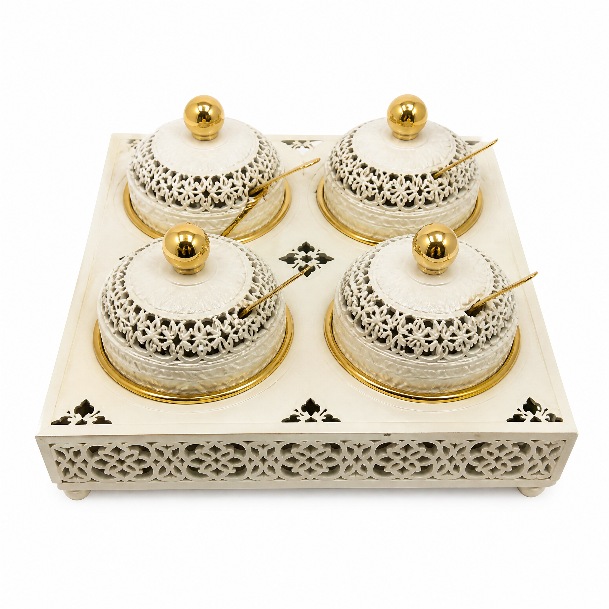 Four ivory and gold lidded jars with ball finials, two by two on a pierced ivory tray