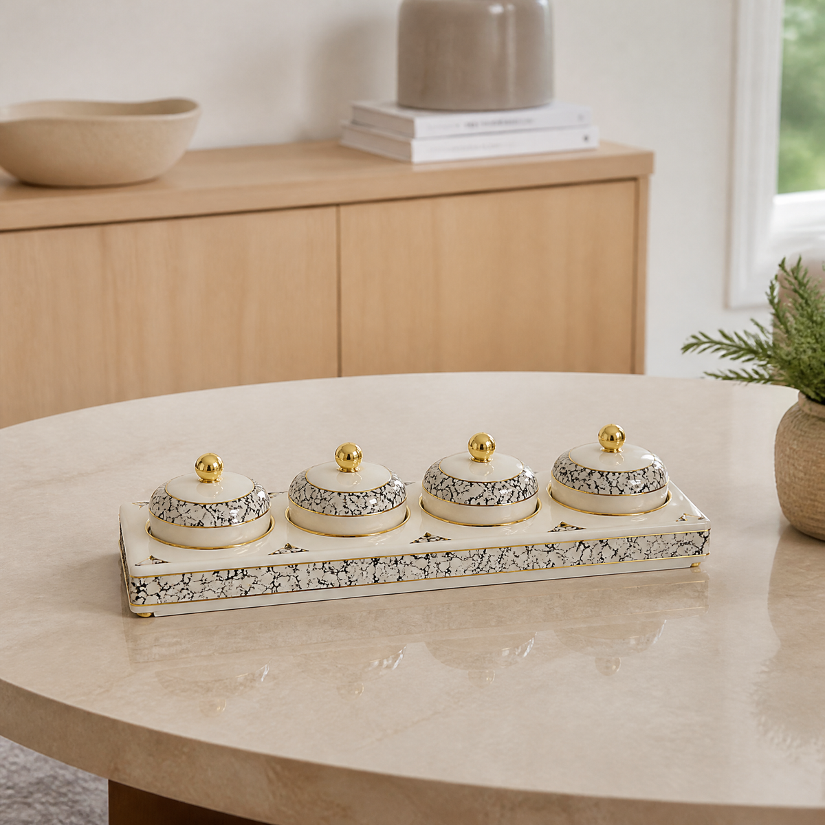 White and gold candy tray with four small lidded gold-topped jars