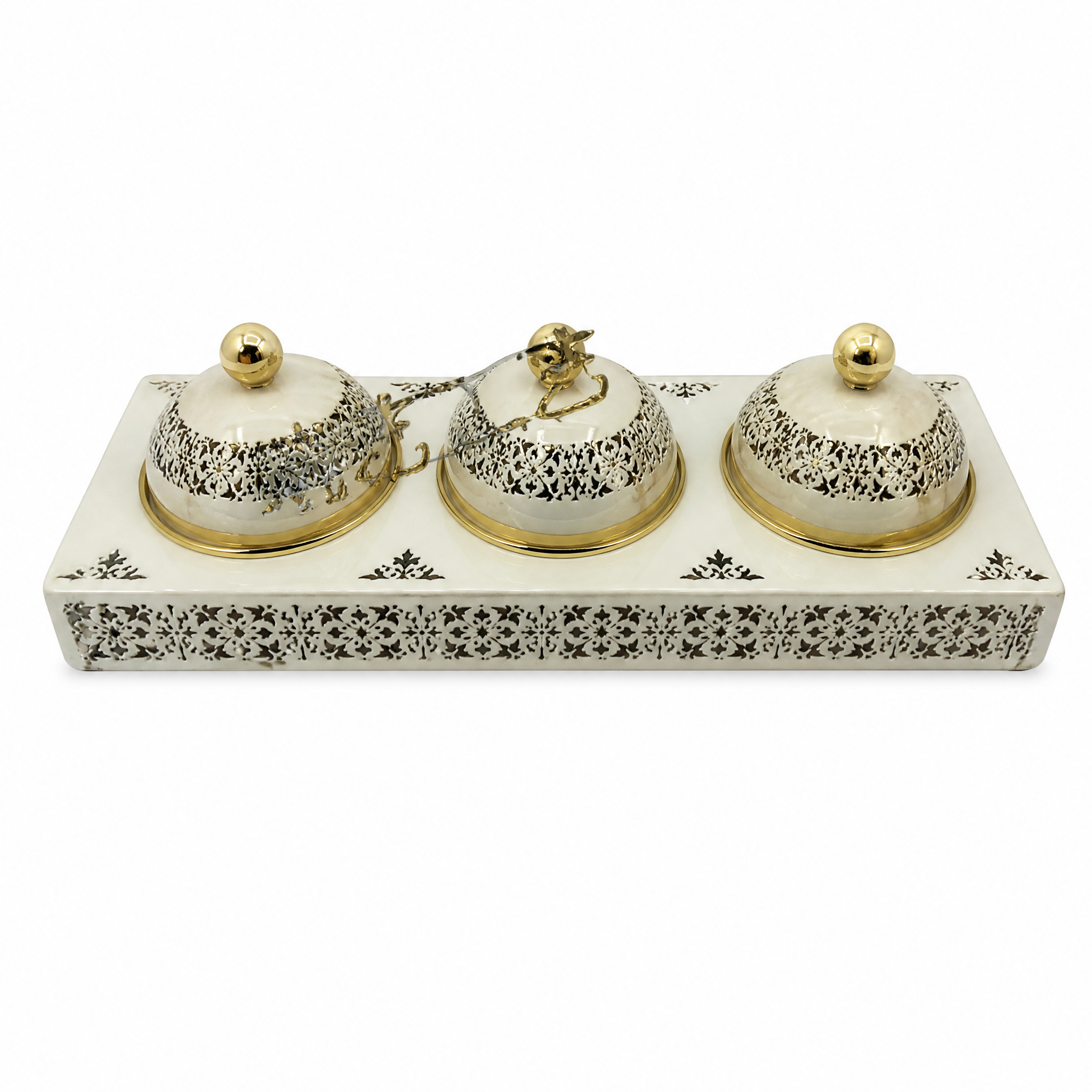 Three ivory domed jars with gold finials on a rectangular pierced ivory and gold tray