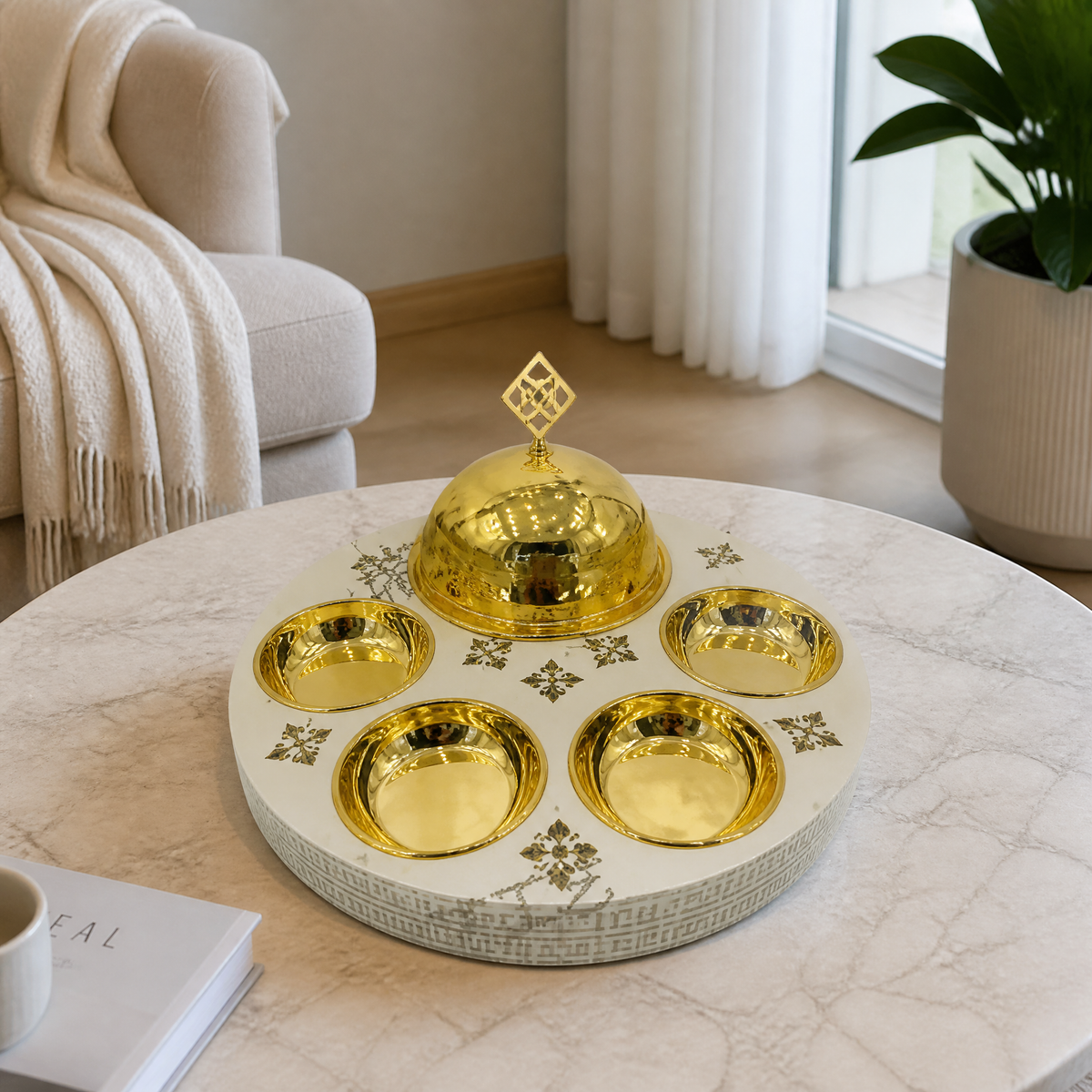 Cream tray with gold-tone fret-pattern rim, smooth gold-tone dome and four gold-tone bowls on marble