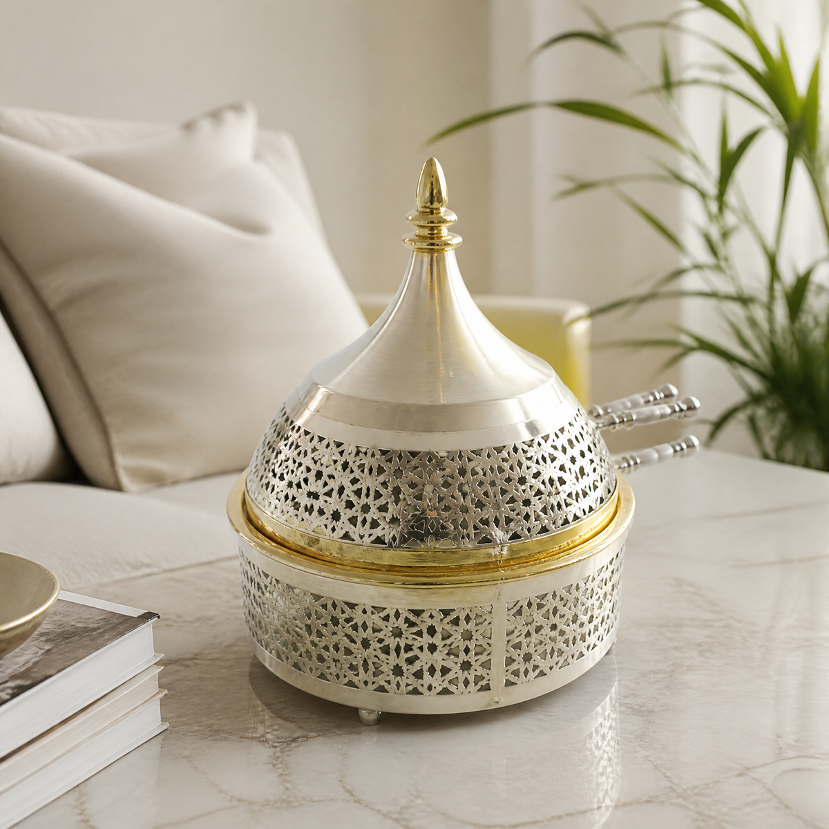 Pierced silver-tone domed candy box with gold-tone trim on a marble tabletop