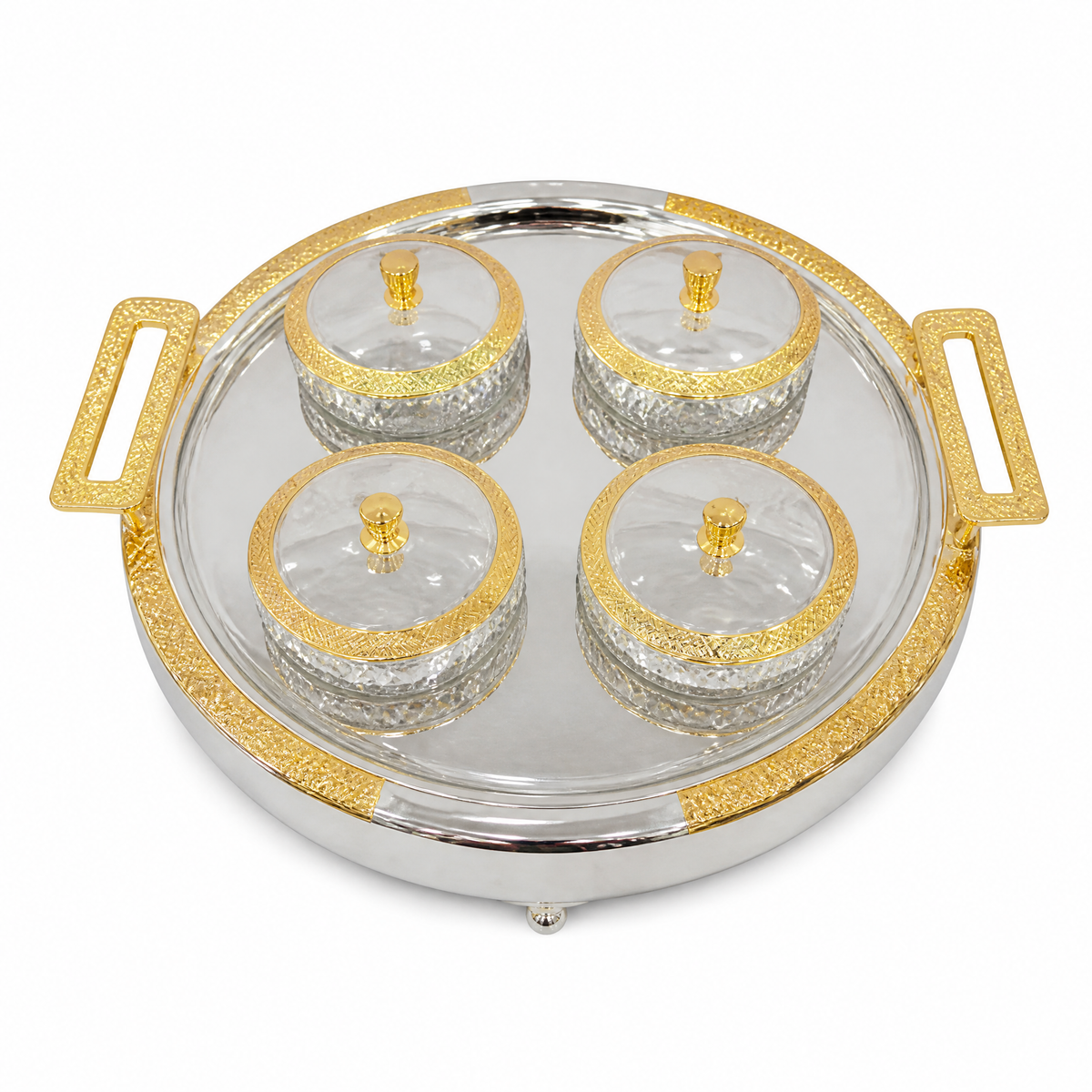 Round silver tray with gold handles holding four clear glass bowls with gold-rimmed glass lids