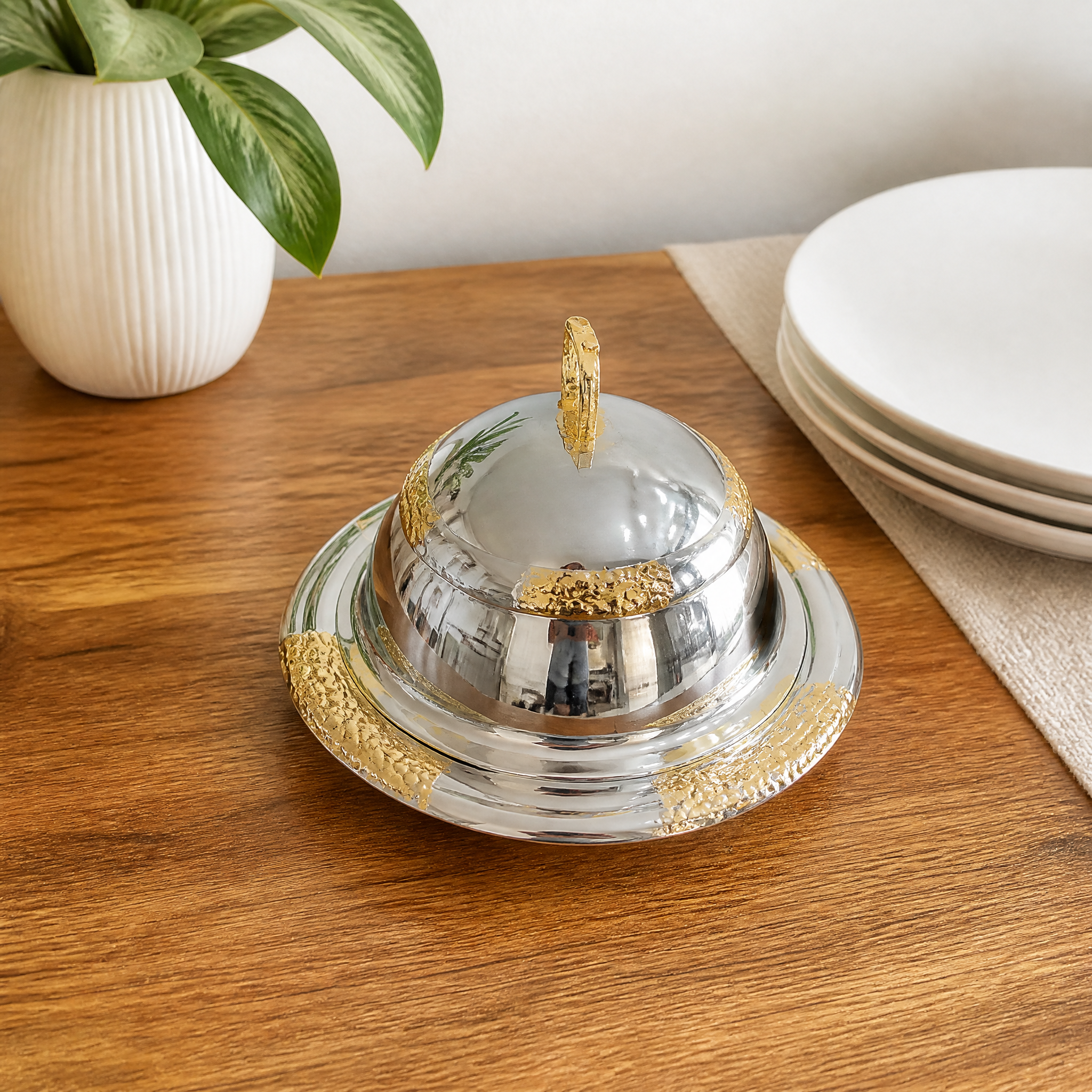 Compact footed silver and gold food warmer with domed lid and gold carry handle