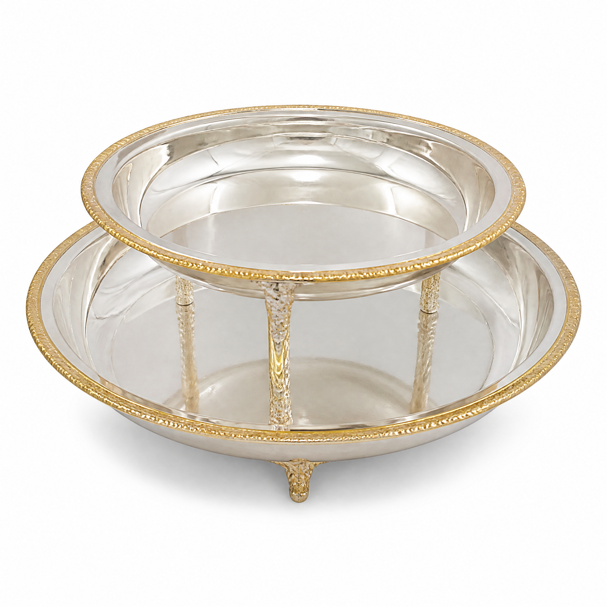 Footed round silver and gold serving bowl with a mirror finish and braided gold rim
