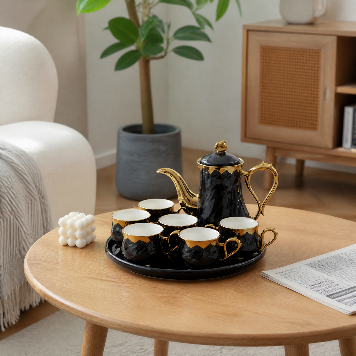 Black and gold tea service with a lidded teapot six cups and a round tray