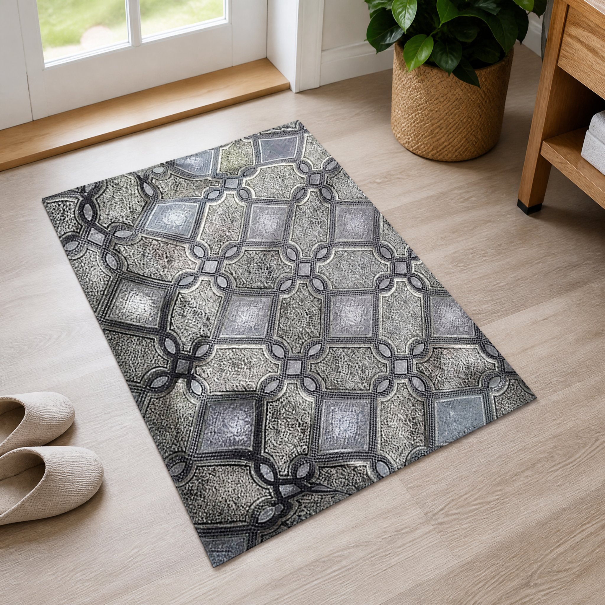 Grey and silver lattice-print fabric panel laid flat on a wood floor beside a doorway