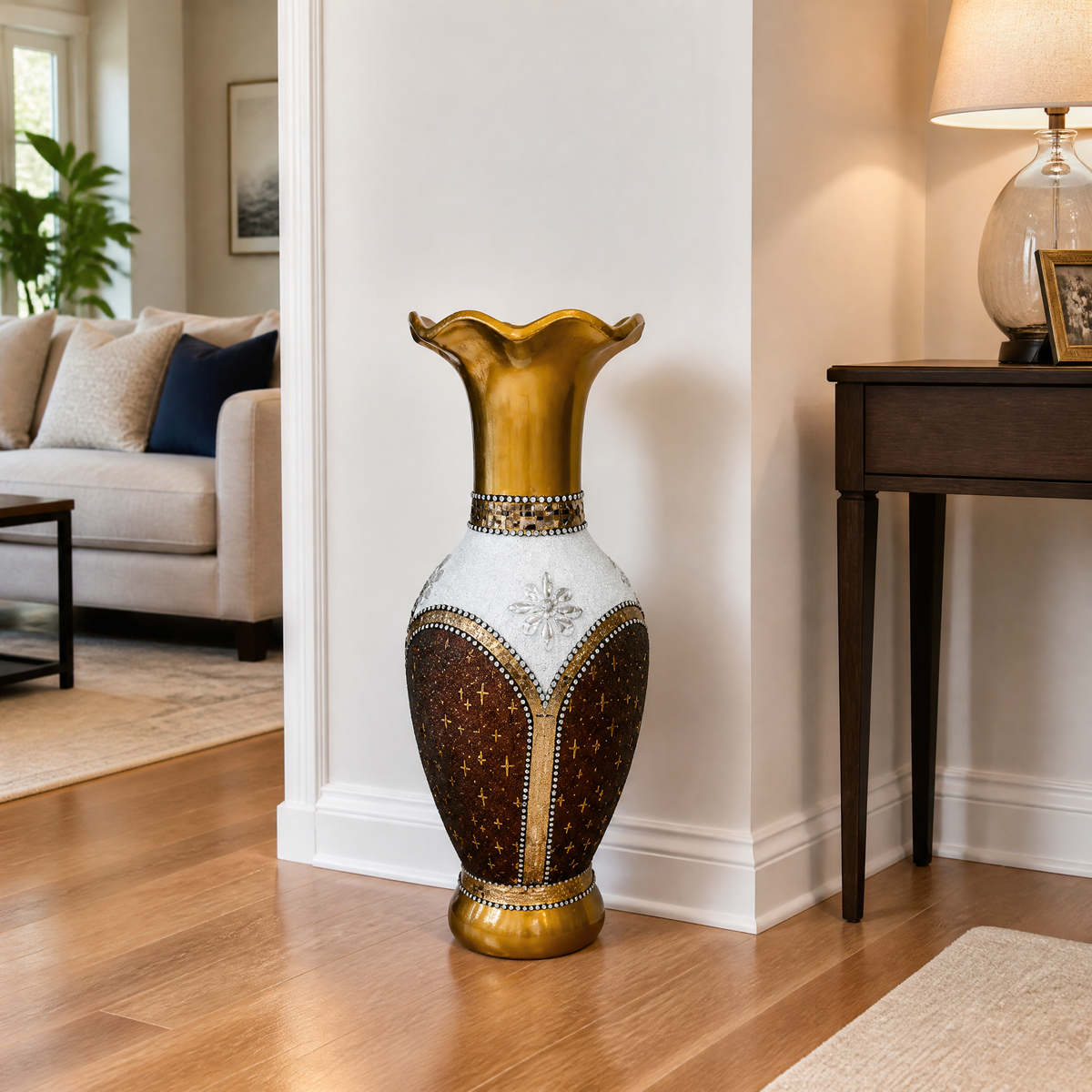 Gold, white and brown floor vase on wood flooring beside a console table