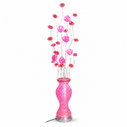 Pink LED floral floor lamp on white, lit flower heads on wire stems above a glowing vase base