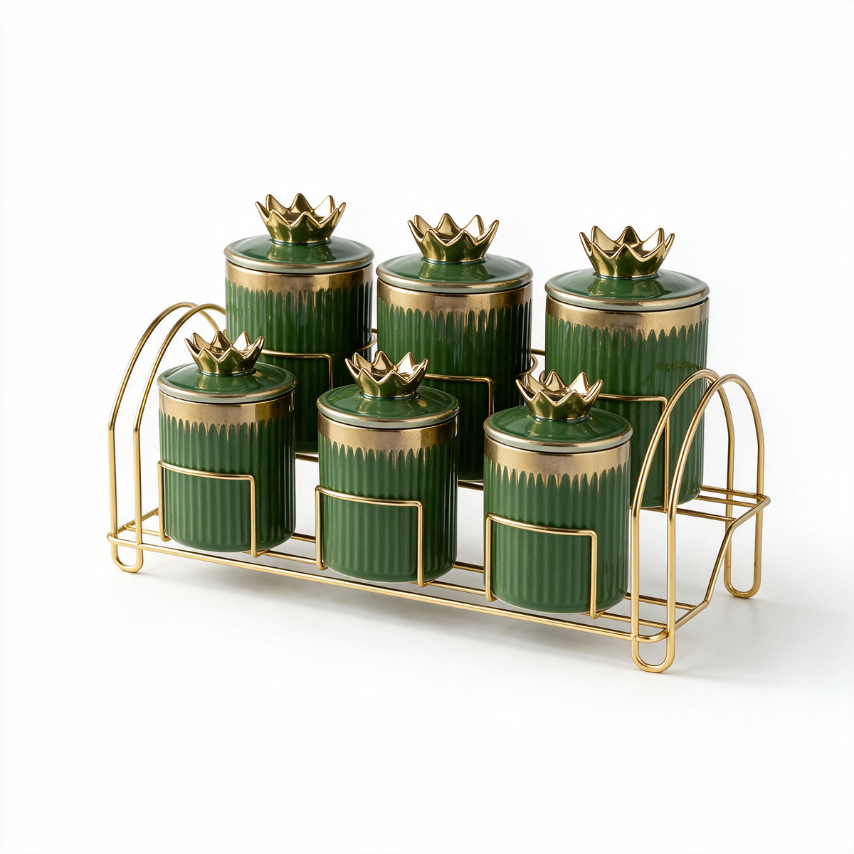 Deep green fluted ceramic spice jars with gold crown lids on a gold-tone stand