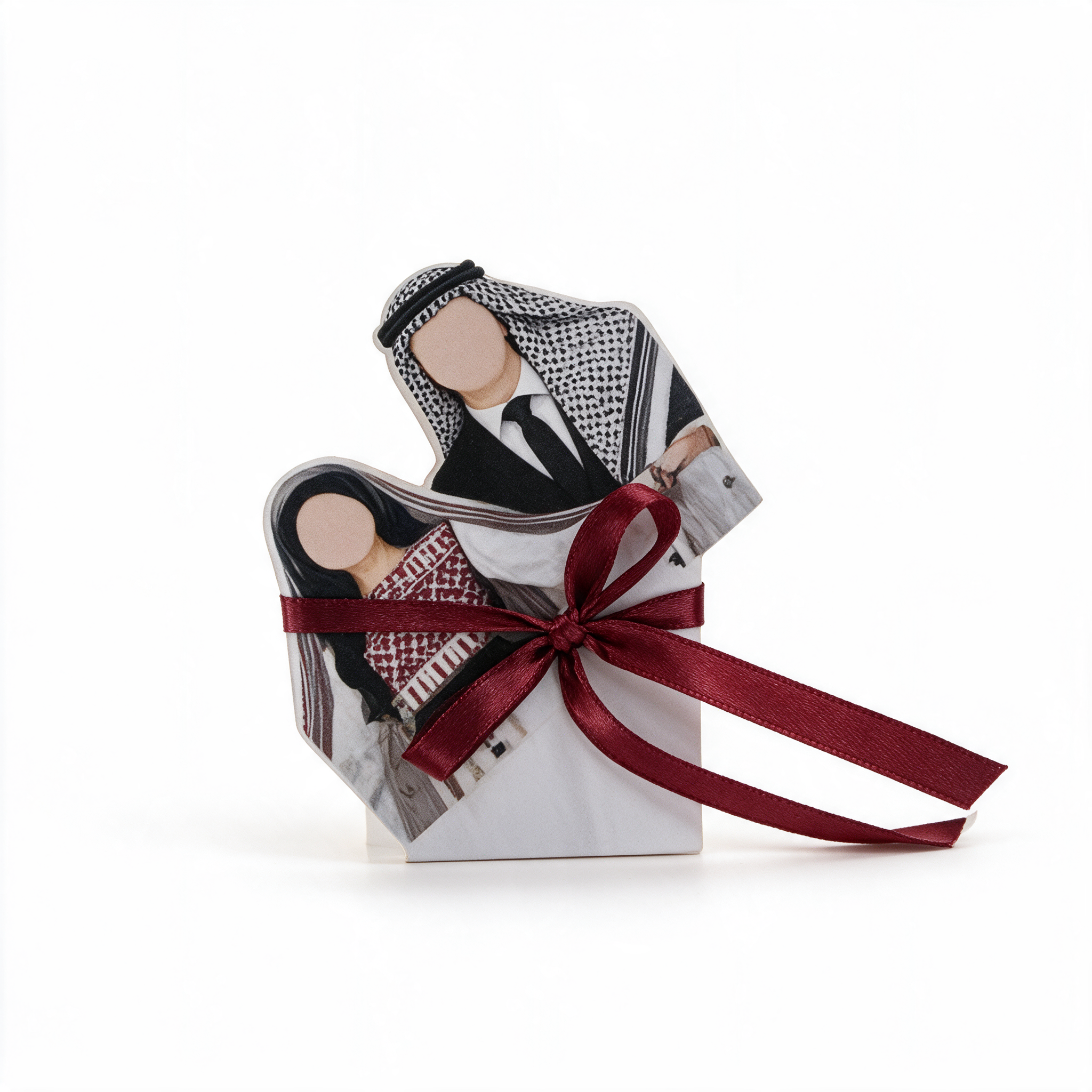 Die-cut standing wedding favor showing a couple in traditional dress, tied with a burgundy ribbon bow
